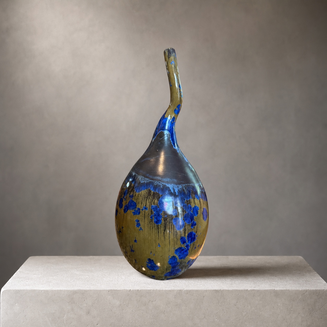 Blue and gold sculptural bottle with a curved neck by Mark Barta