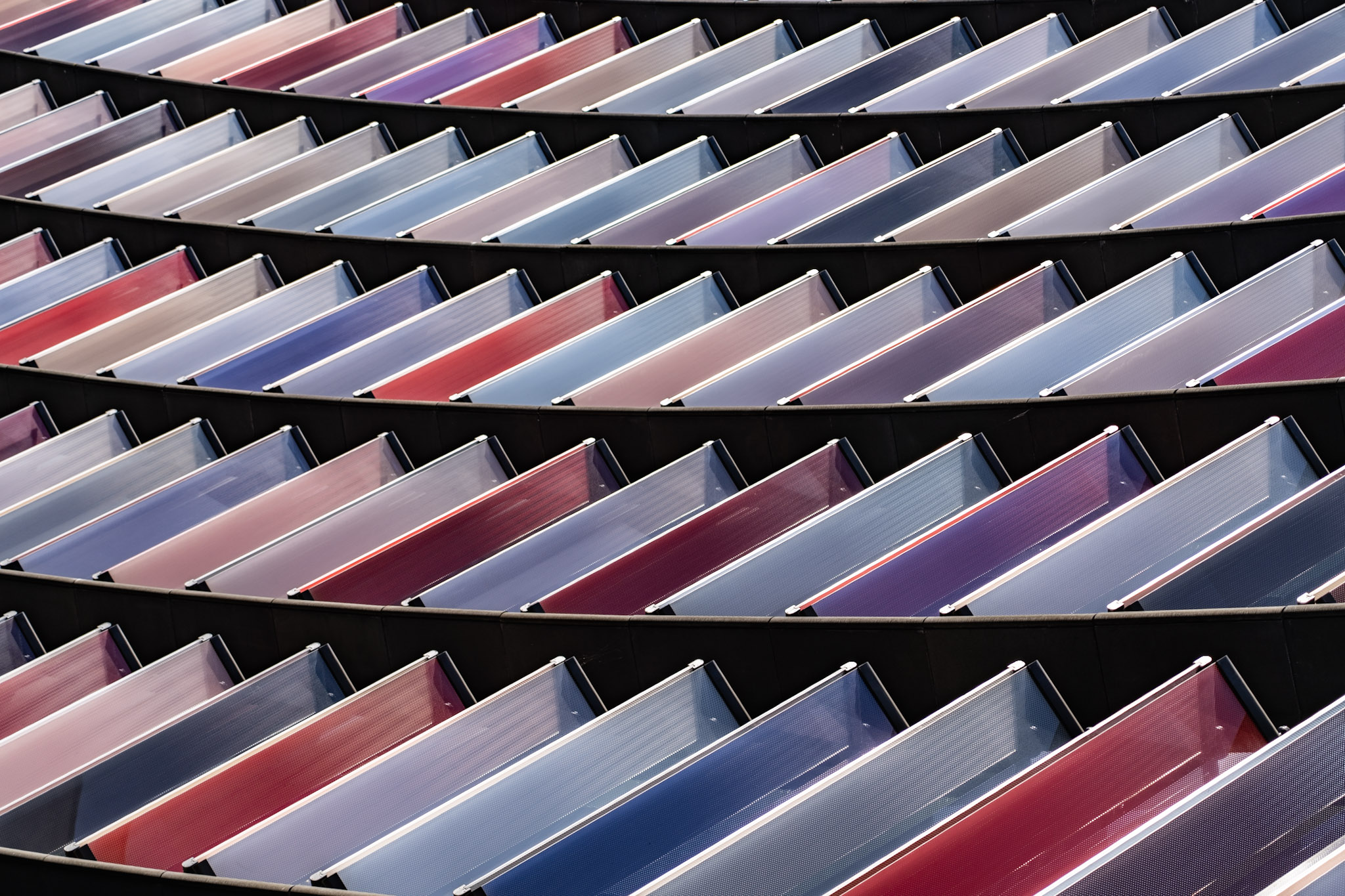 Rows of red, blue, silver, and translucent glass louvres on Two New Ludgate in London