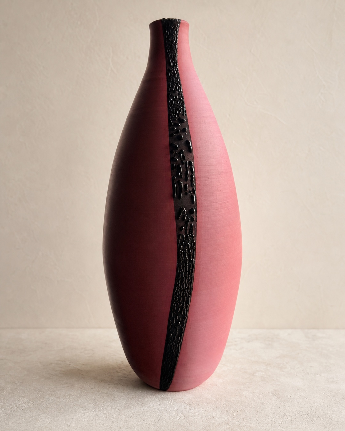 Pink and maroon sculptural ceramic bottle with a raised black vertical strip by Mark Barta